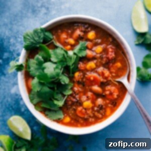 Close-up of a rustic bowl of Quinoa Vegetable Soup, garnished and ready to be served.
