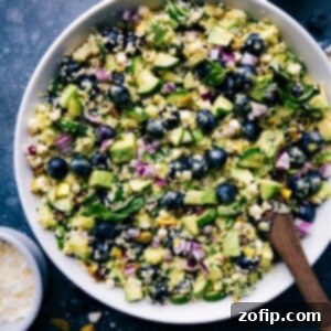 Sweet & Tangy Summer Corn Salad with Blueberries 3 Overhead view of a vibrant Blueberry Corn Salad in a bowl, garnished with fresh basil.