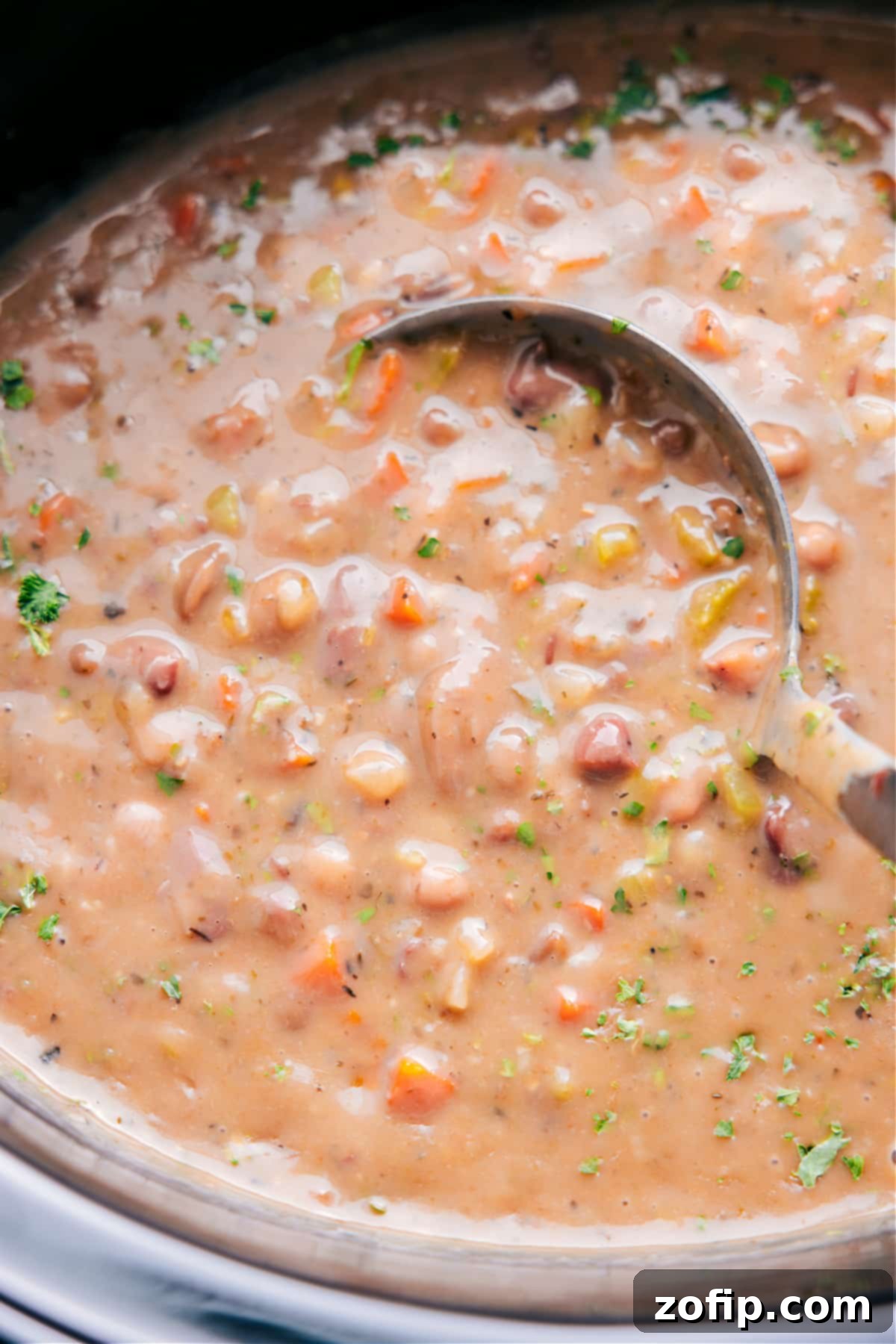 Scooping up 15-Bean Soup with a ladle, ready to enjoy.