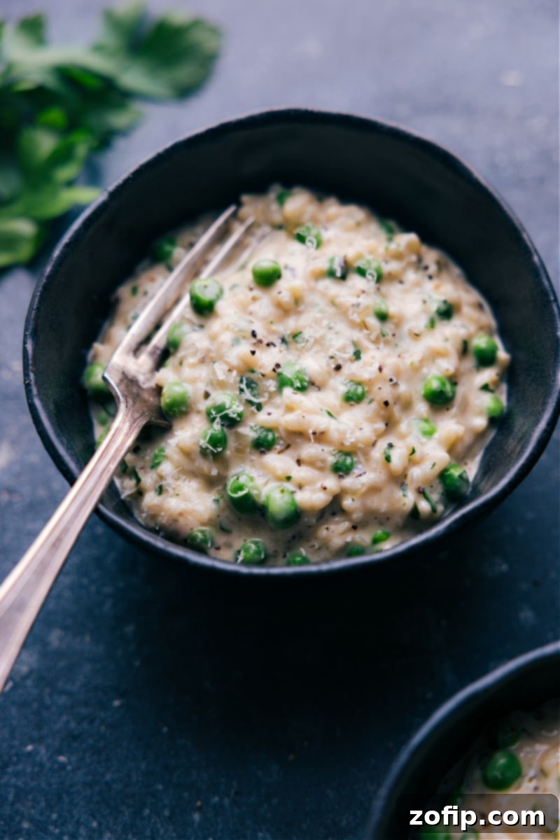 Overhead view of a beautiful bowl of creamy Instant Pot Risotto, garnished with fresh herbs.