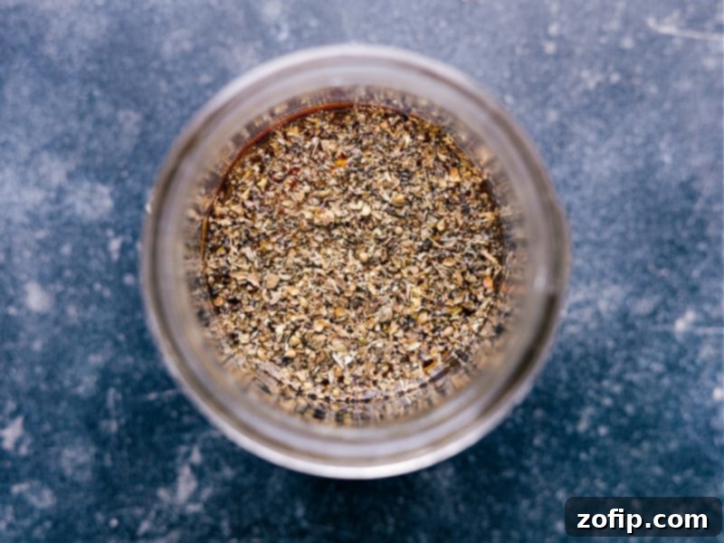 Close-up of olive oil, red wine vinegar, Dijon mustard, and honey, the core ingredients for a simple vinaigrette.