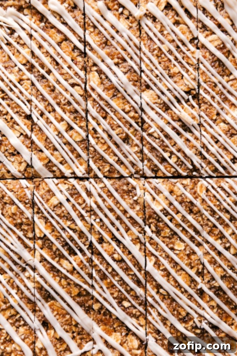 Delicious Oatmeal Granola Bars with a sweet white chocolate icing drizzle, perfect for a healthy snack.