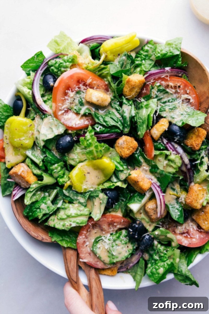 A beautifully dressed Olive Garden Salad copycat, prepared for a delightful meal, showcasing fresh ingredients and vibrant colors, ready to be enjoyed.
