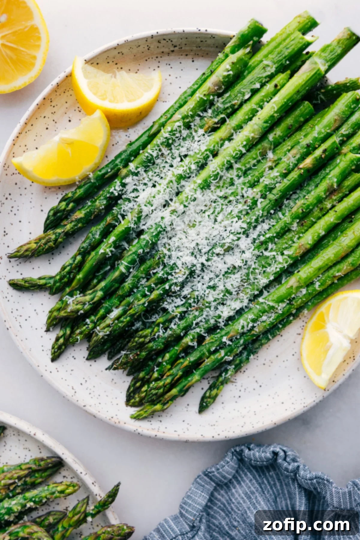Roasted Asparagus: Your Ultimate Guide Easy roasted asparagus with fresh parmesan cheese and lemon slices.