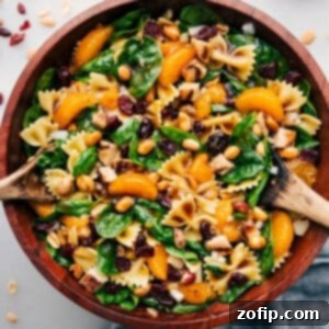 Teriyaki Chicken Salad in a bowl ready to be served at your next event, featuring a forkful of the delicious mix.