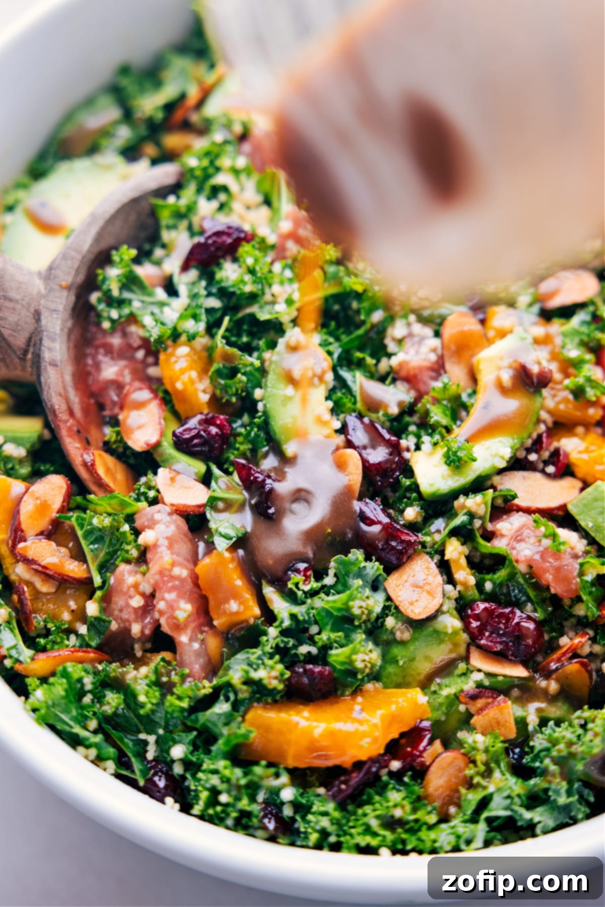 The delicious balsamic dressing being poured generously over the easy grapefruit salad, enhancing its flavors.