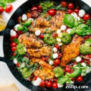 Close-up of a serving of Caprese Chicken with mozzarella, basil, and balsamic.