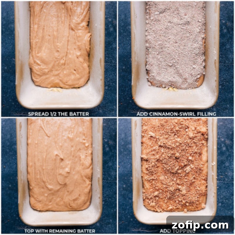 Process shot depicting the final layering of cinnamon bread batter into a prepared 9x5-inch loaf pan, showcasing the swirl before baking.