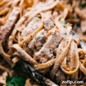 Delicious Chicken Alfredo ready to be served in a bowl, garnished with fresh parsley.