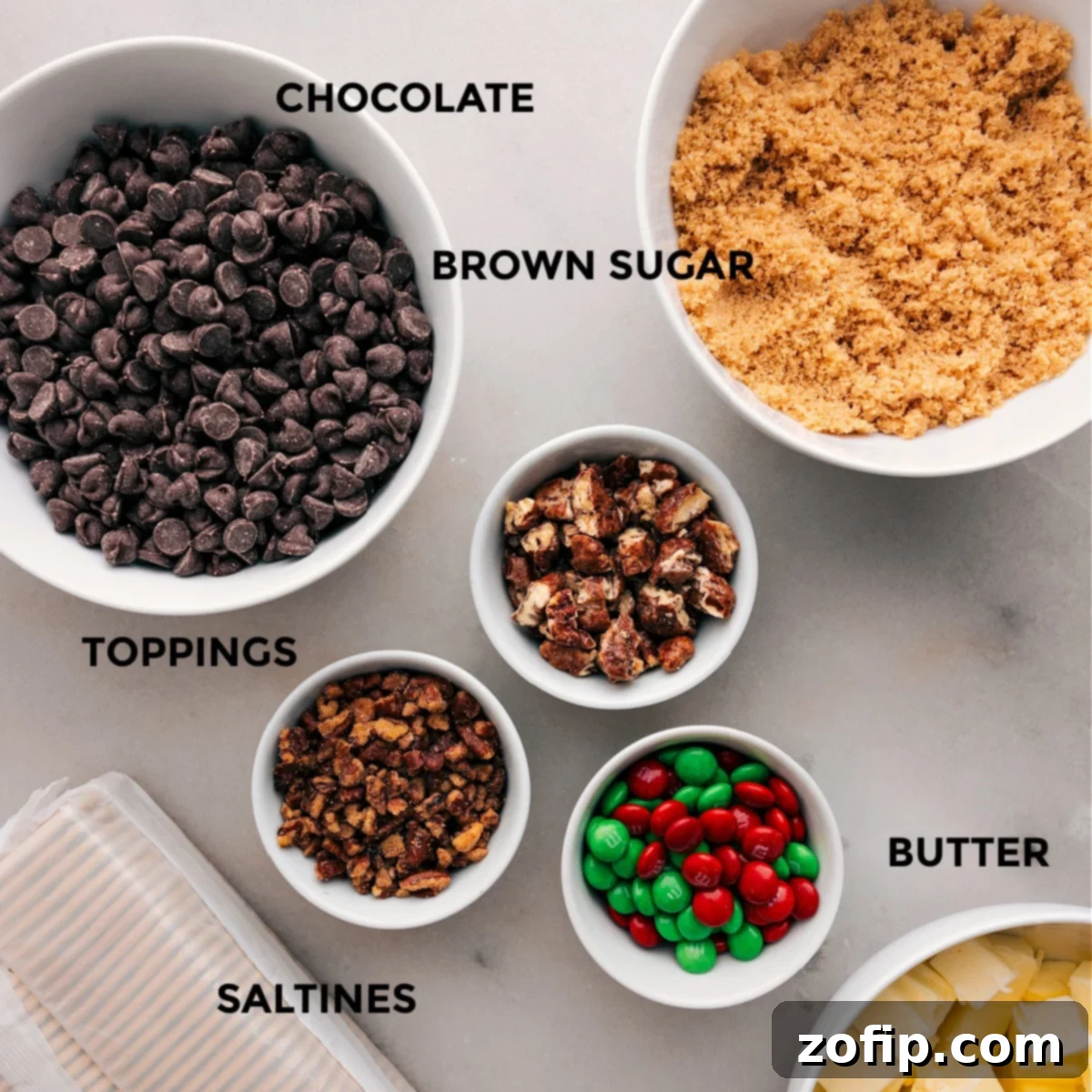 Christmas Crack (AKA Saltine Toffee) Ingredients All the essential ingredients for making Christmas Crack are neatly prepped: chocolate chips, light brown sugar, toppings, unsalted butter, and saltine crackers.