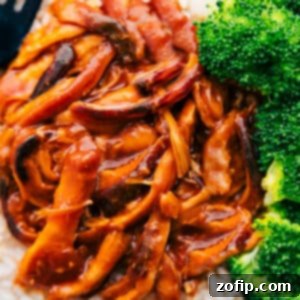 Close-up of shredded honey garlic chicken thighs coated in a rich, glossy sauce, ready to be served.