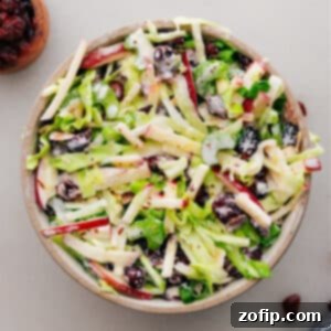 Apple Coleslaw finished dish in a serving bowl with a small portion on a plate