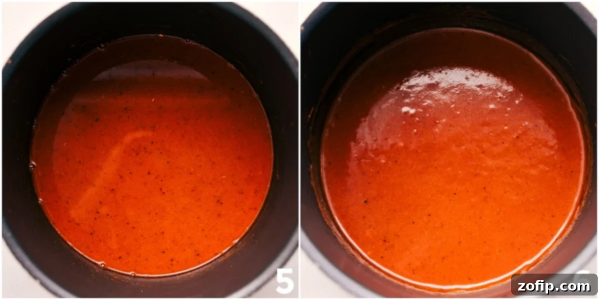 Simmering Enchilada Sauce Chicken broth being slowly added to the pan of sautéed spices and tomato paste, carefully whisking to create a smooth, lump-free enchilada sauce.