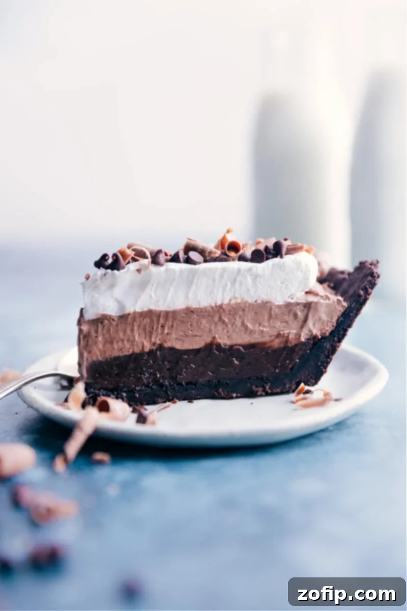 Velvety Chocolate Cloud Pie 3 A perfectly sliced piece of layered Chocolate Pudding Pie ready to be enjoyed, showcasing its rich texture.