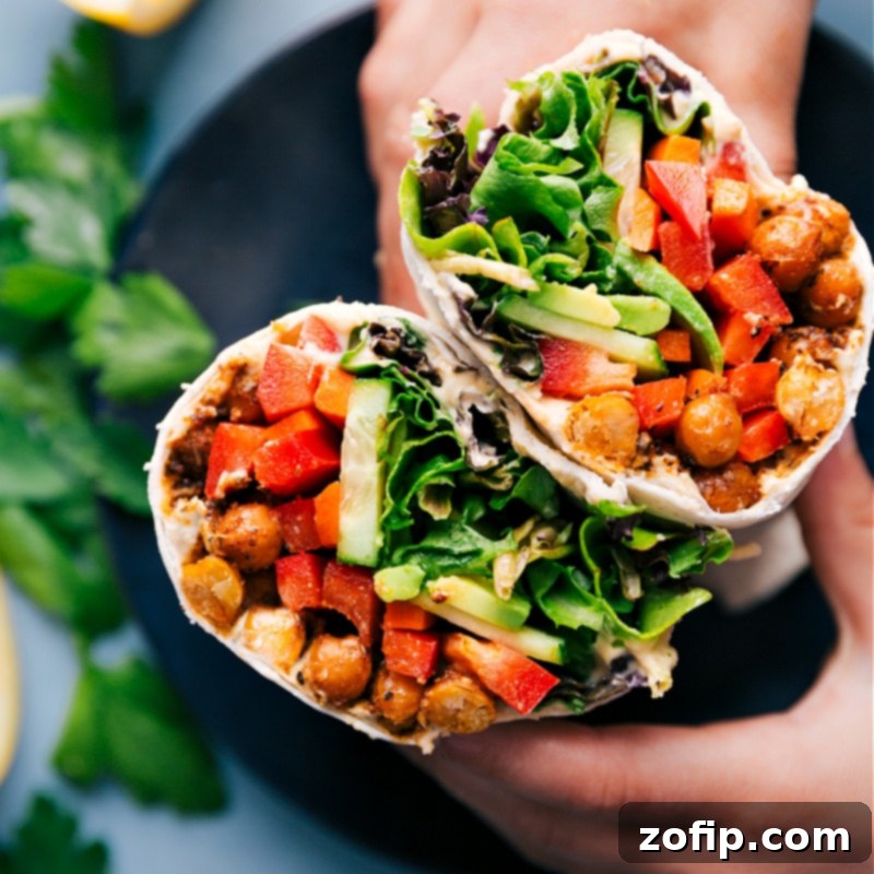 Close-up overhead view of two beautifully assembled Hummus Wraps, highlighting the vibrant ingredients and crispy chickpeas.