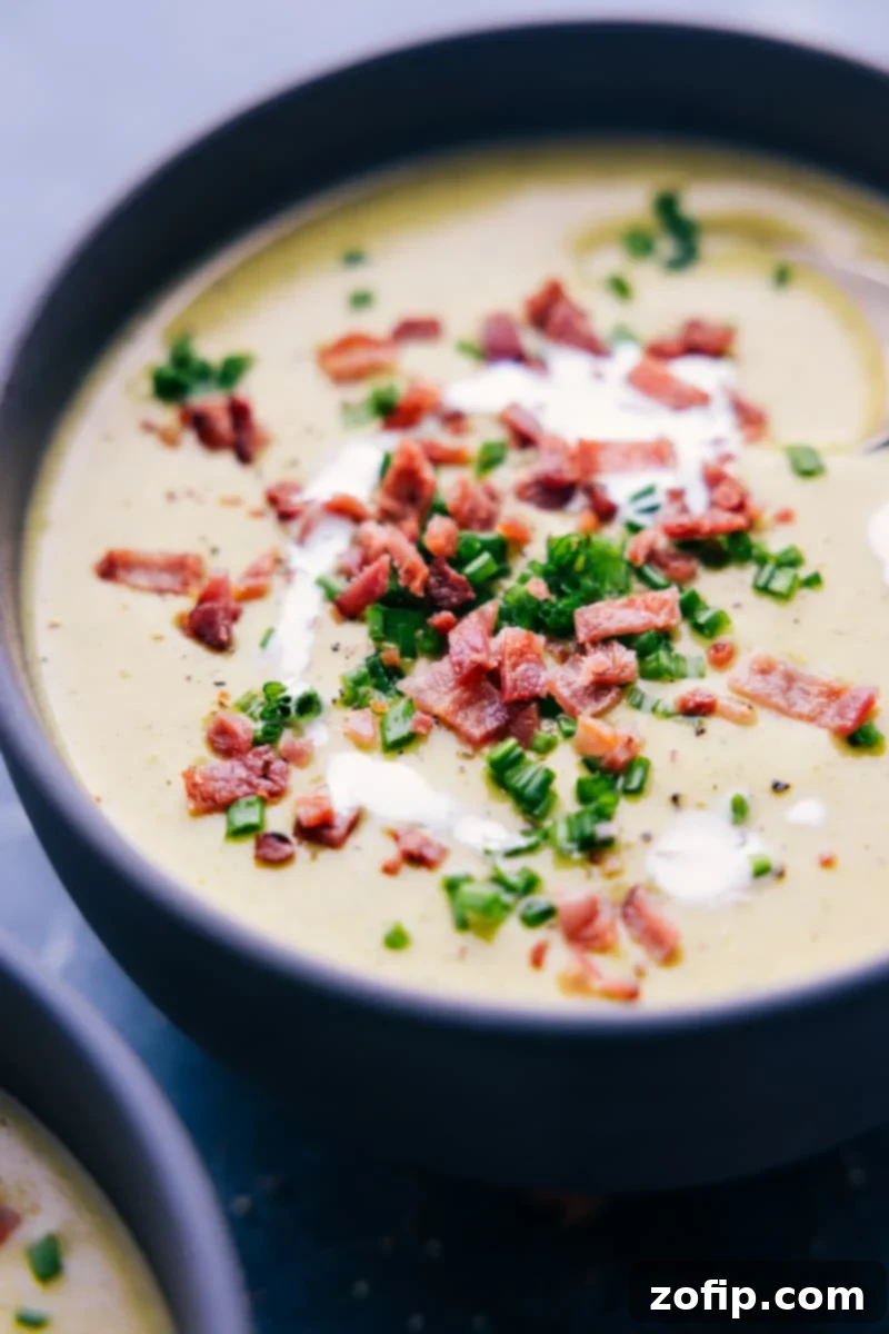 Creamy Broccoli Delight 6 A beautifully presented bowl of creamy cheesy broccoli soup, ready to be served, garnished with a swirl of cream and fresh parsley.