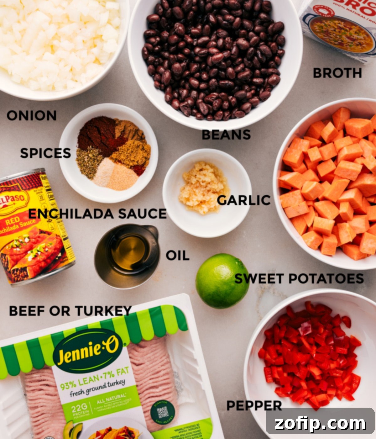 Ingredients In Beef Enchilada Soup A vibrant selection of fresh ingredients including diced sweet potatoes, onions, red bell pepper, black beans, ground meat, garlic, and various spices, all prepped and ready for the Beef Enchilada Soup recipe.