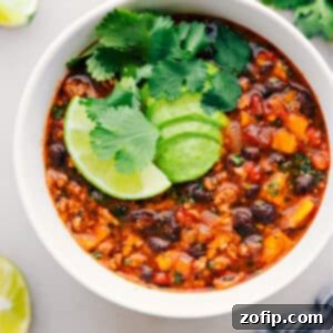 Ultimate Beef Enchilada Soup 2 A delicious bowl of Beef Enchilada Soup, garnished with fresh cilantro and a dollop of sour cream.