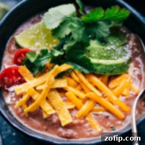 Hearty Pinto Bean Soup 3 A bowl of creamy Pinto Bean Soup, garnished and ready to be served.