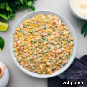 Mexican Street Corn Dip in a bowl with chips ready to be enjoyed.