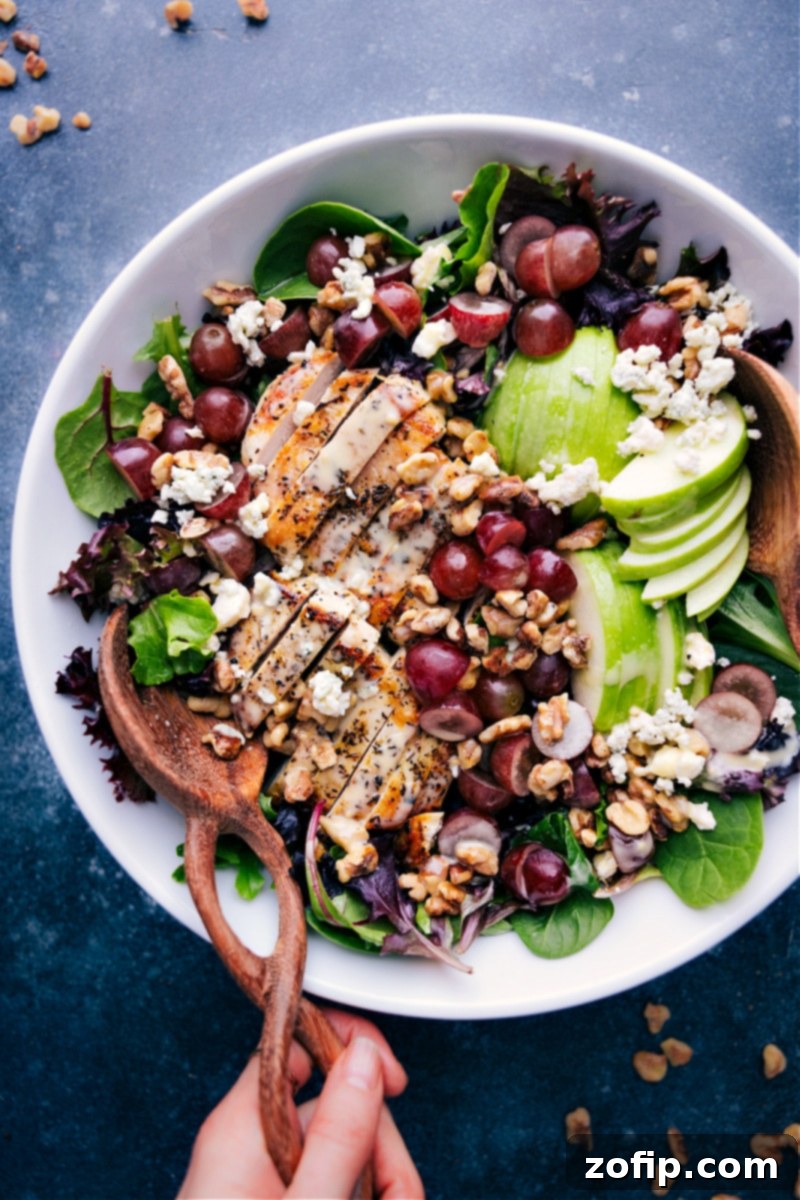 Versatile and delicious Honey Mustard Vinaigrette is perfect for any occasion. It's the ultimate balance of sweet and tangy, with a creamy texture. Use it to elevate your salads to the next level, marinade your meats or poultry, or use it as a unique dip for your veggies. Overhead view of a vibrant dinner salad generously drizzled with homemade Honey Mustard Vinaigrette, showcasing its creamy texture and rich color.