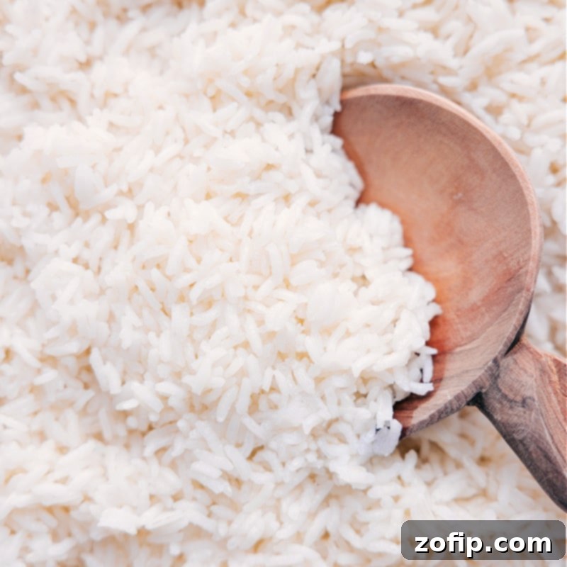 Perfectly cooked white rice, fluffed and ready to be served, a versatile base for any meal.