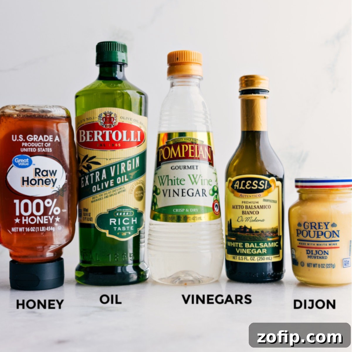 All the individual ingredients laid out for crafting the flavorful White Balsamic Vinaigrette for this arugula salad recipe.