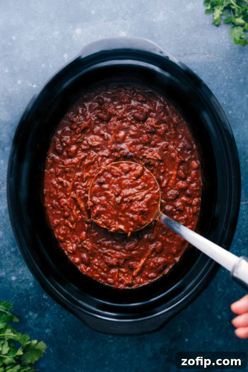 Overhead image of the freshly cooked Chili Con Carne simmering in the slow cooker, ready to be served.