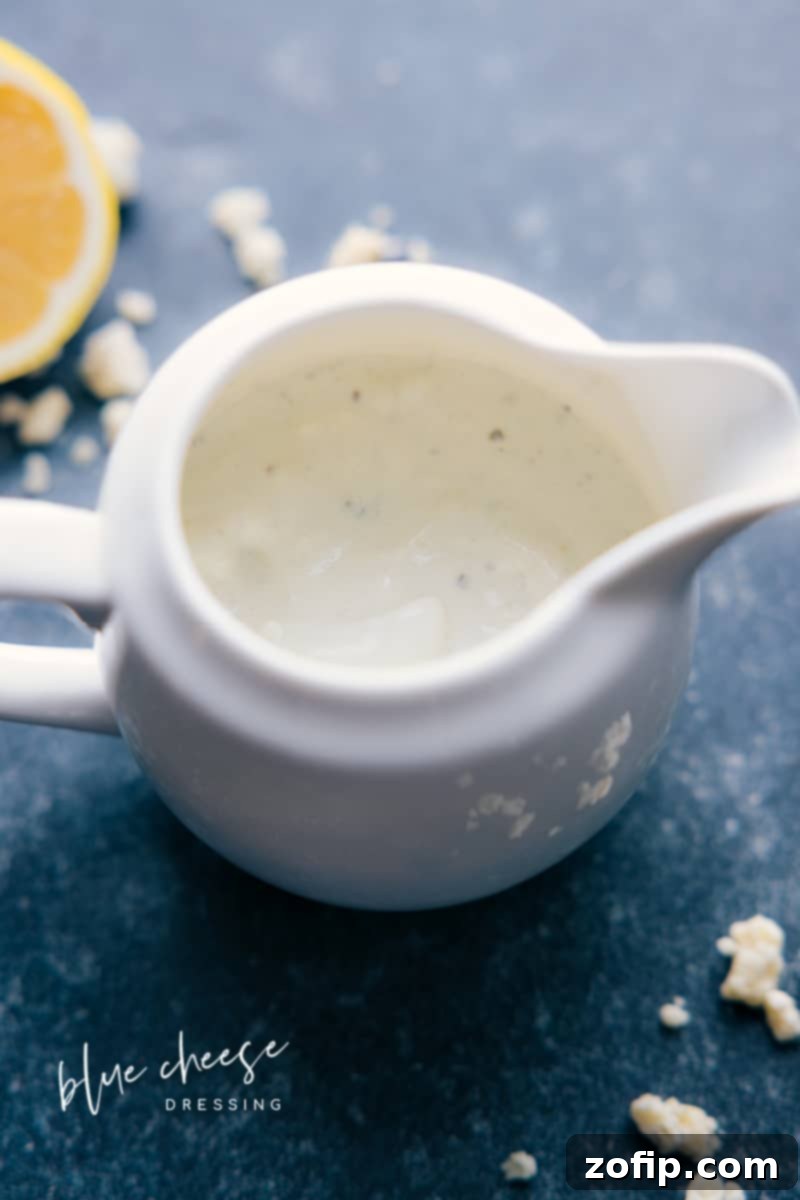 The ultimate creamy, tangy, and delicious homemade Blue Cheese Dressing recipe for salads and dips. Overhead image of a bowl of creamy homemade Blue Cheese Dressing, garnished with fresh chives, ready to be served.