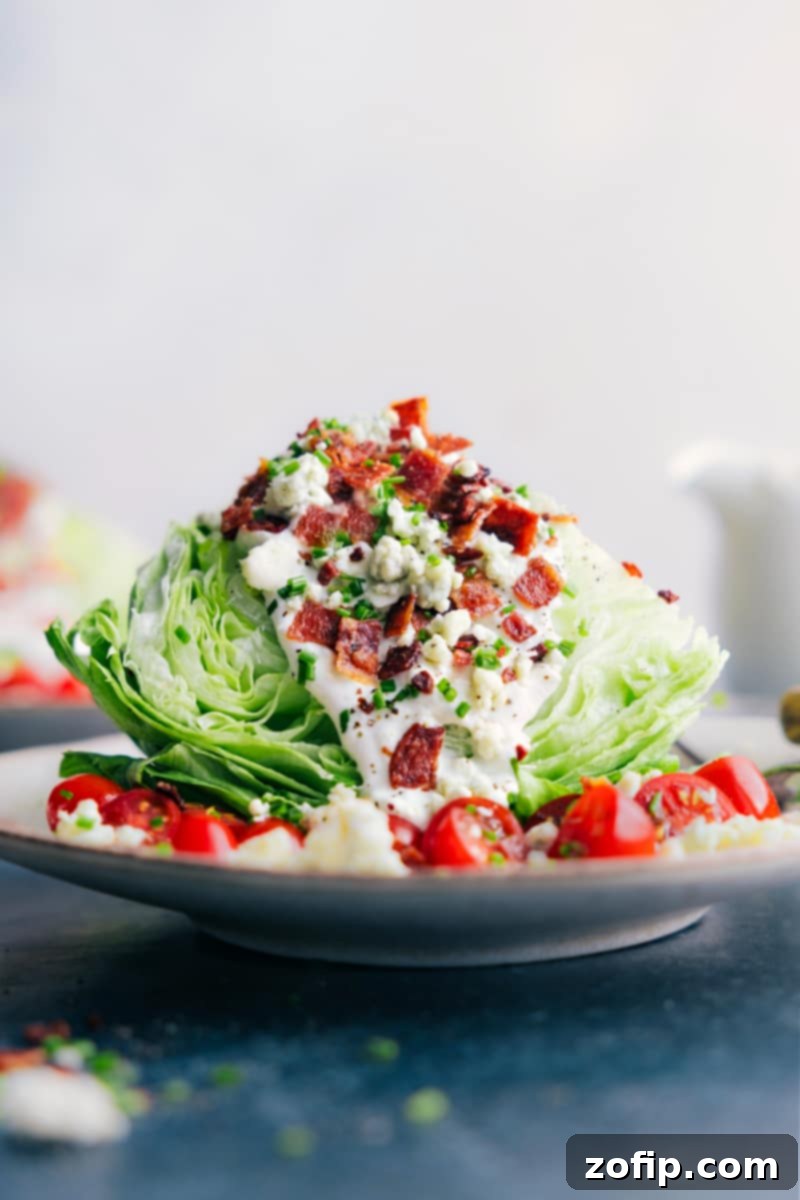 Perfect Blue Cheese Dressing on a classic wedge salad, highlighting its creamy and chunky texture. Close-up image of the homemade Blue Cheese Dressing generously poured over a fresh wedge salad, showcasing its rich texture and chunks of blue cheese.
