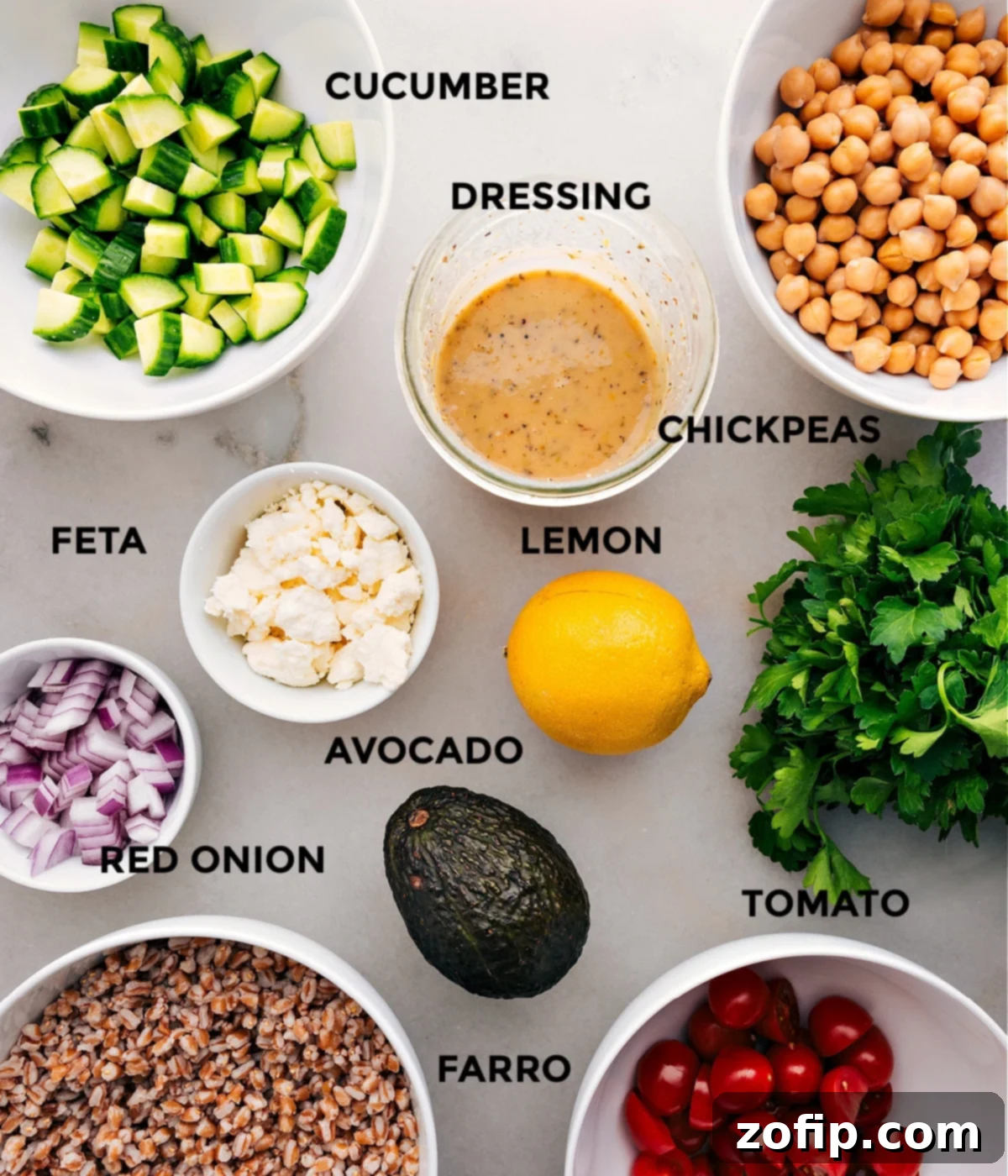 This recipe includes prepped ingredients like dressing, chickpeas, veggies, feta, lemon, farro, and parsley for easy assembly, highlighting meal prep benefits.