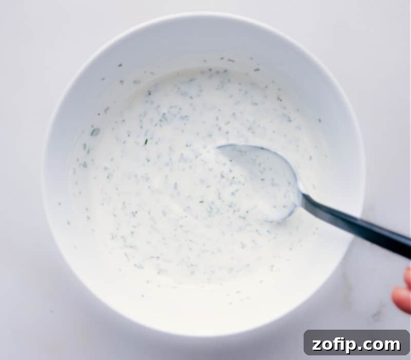 A bowl of fresh, creamy homemade Ranch Dressing, perfect for dipping or drizzling. Image of homemade Ranch Dressing in a serving bowl, garnished with fresh herbs, ready to be enjoyed as a dip or dressing