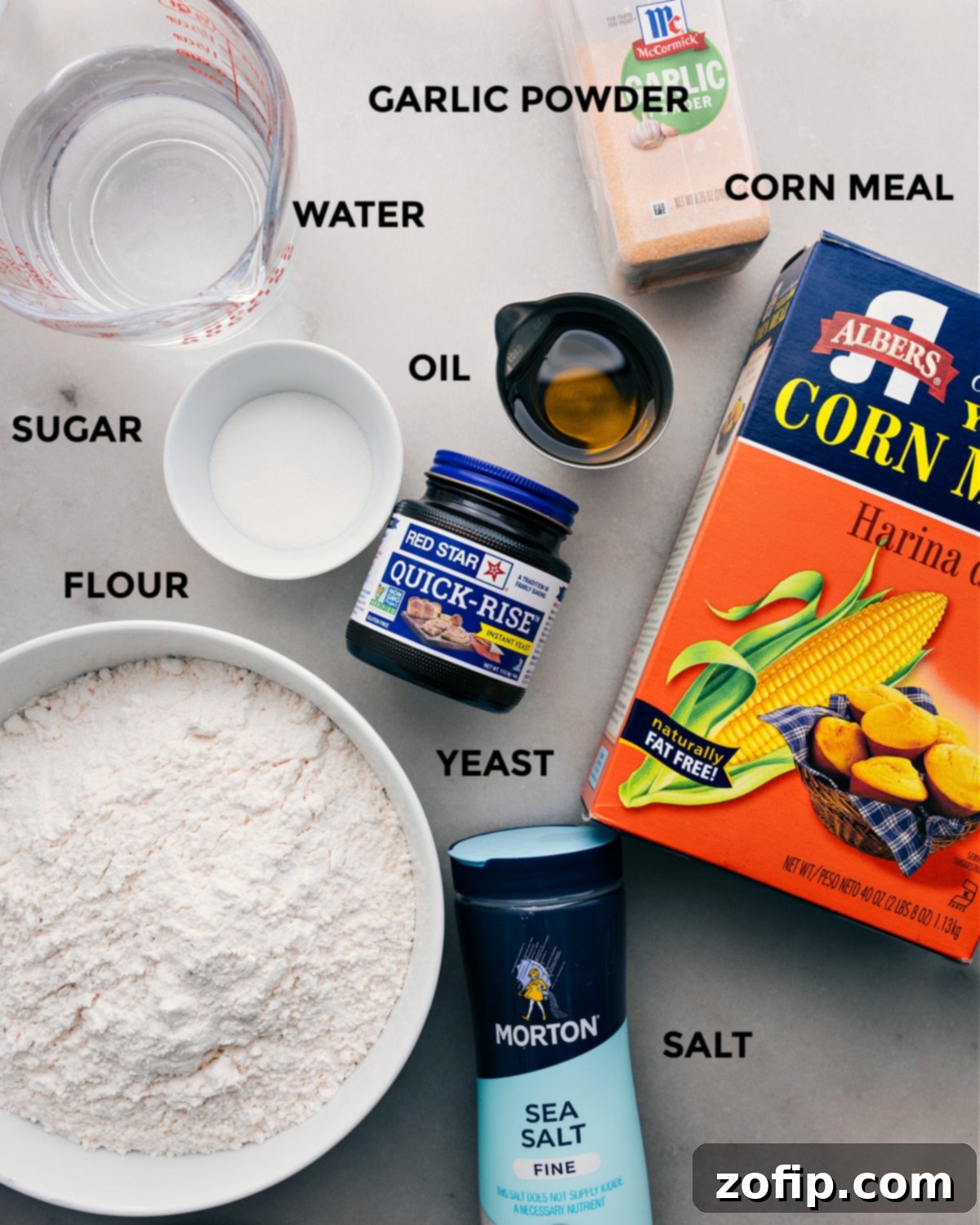 All the fresh ingredients for this easy pizza dough recipe, including flour, yeast, olive oil, and water, prepped for use.
