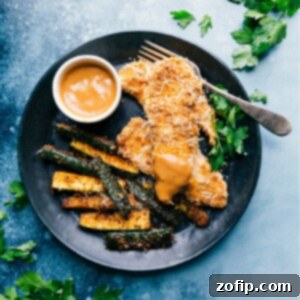 Crispy Sheet Pan Chicken and Zucchini served with dipping sauce.