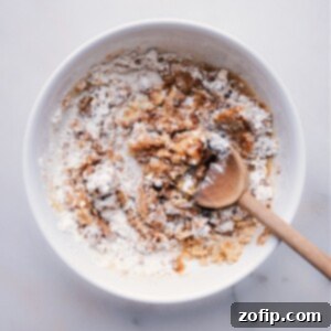 The Ultimate Streusel Guide 4 Melted butter is being poured into a bowl containing flour, brown sugar, cinnamon, and salt, ready for mixing to create streusel.