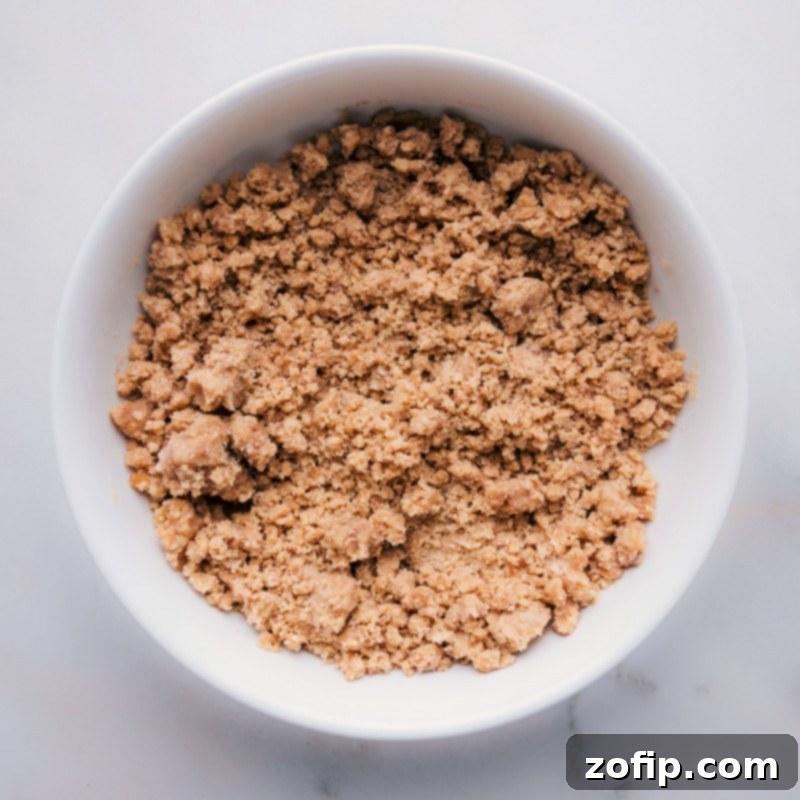 Our recipe ensures you can make the perfect streusel for your next dessert, offering a sweet and crunchy topping every time. Recipe via chelseasmessyapron. A close-up view of freshly made streusel in a bowl, showcasing its perfectly coarse and crumbly texture, ready for topping.