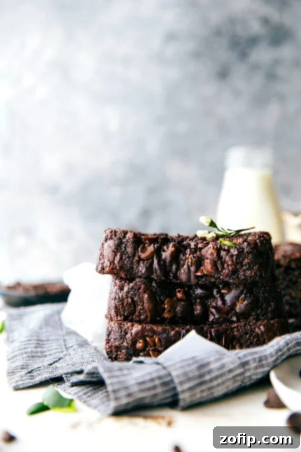 Stacked slices of moist Chocolate Zucchini Bread with chocolate chips