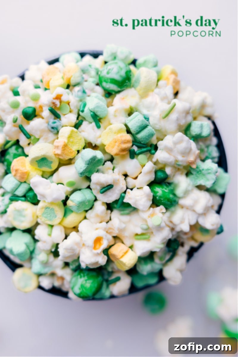 Overhead image of the St. Patrick's Day Popcorn, showcasing the colorful mix of M&M's, Lucky Charms marshmallows, and sprinkles on white chocolate coated popcorn.