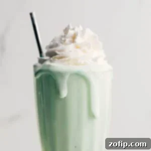 Homemade Shamrock Shake with whipped cream and cherry.
