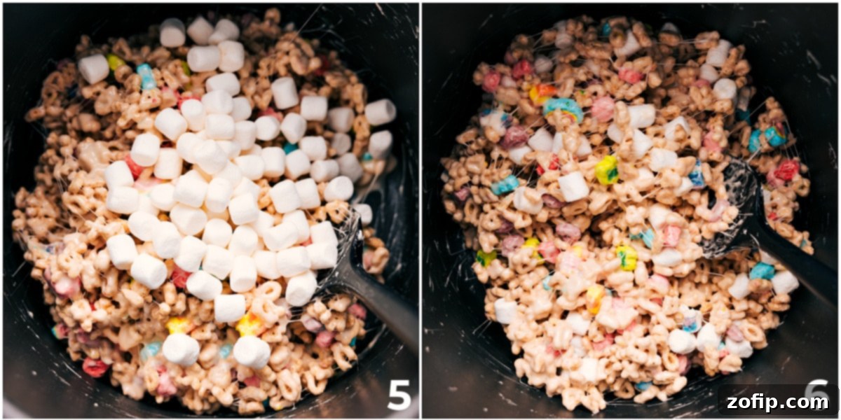 The Lucky Charms cereal and marshmallows mixed together in a bowl, ready to be pressed into a pan.