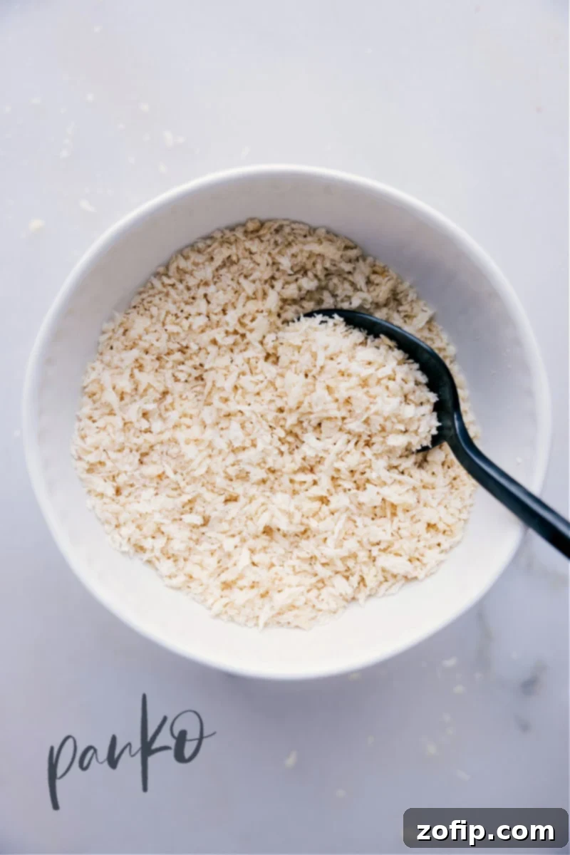 A bowl of light, flaky panko breadcrumbs, ready for cooking.
