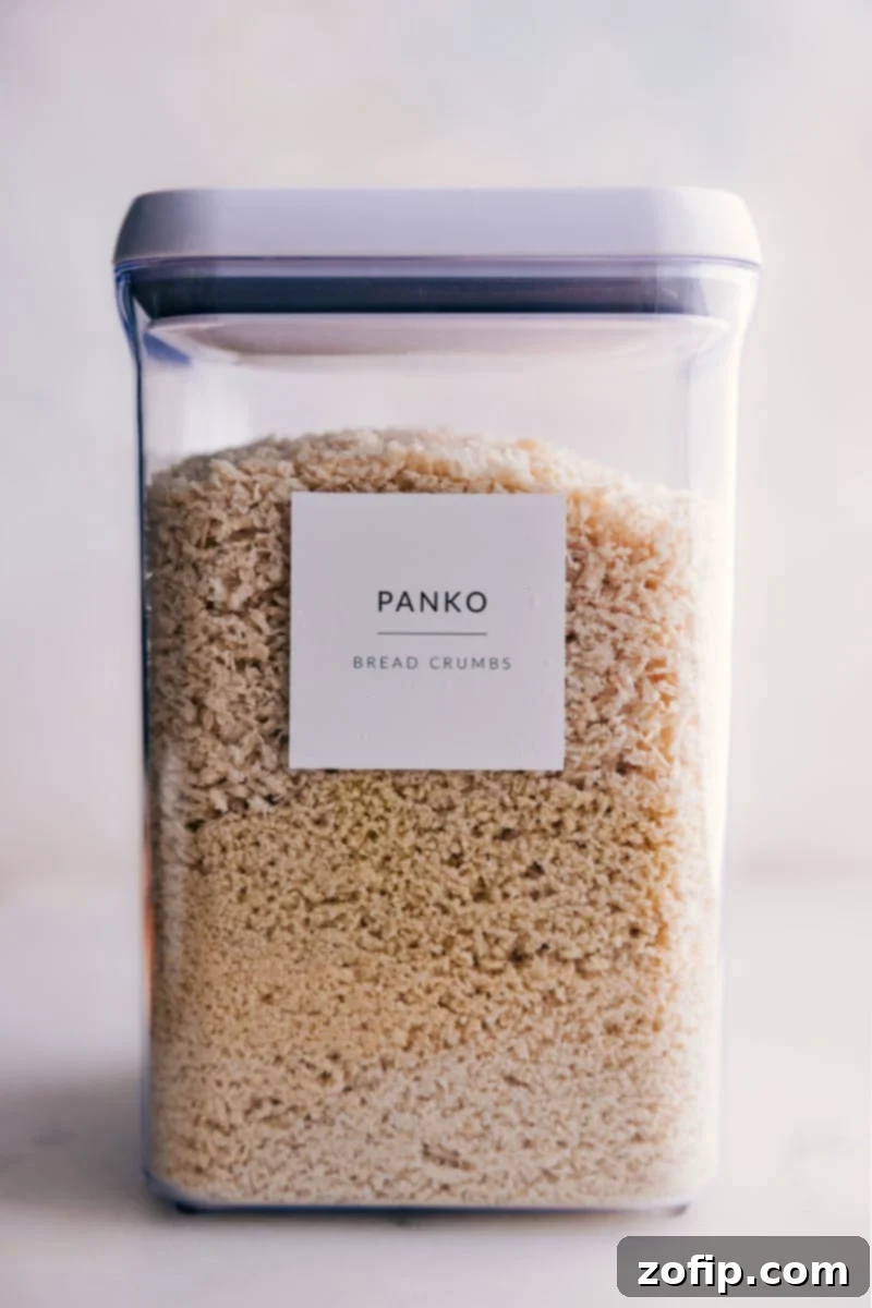 A large container of panko breadcrumbs, ready for use in a kitchen.