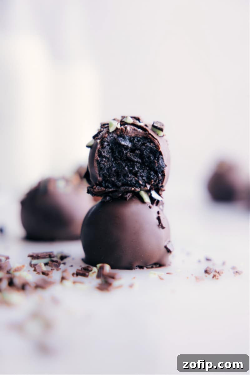 Elegant stack of Mint Oreo Truffles on a serving platter, showcasing their smooth chocolate coating and a hint of minty green filling.