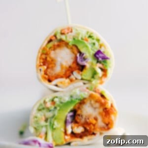 A freshly made Buffalo Chicken Wrap, cut in half, showcasing all the delicious layers.
