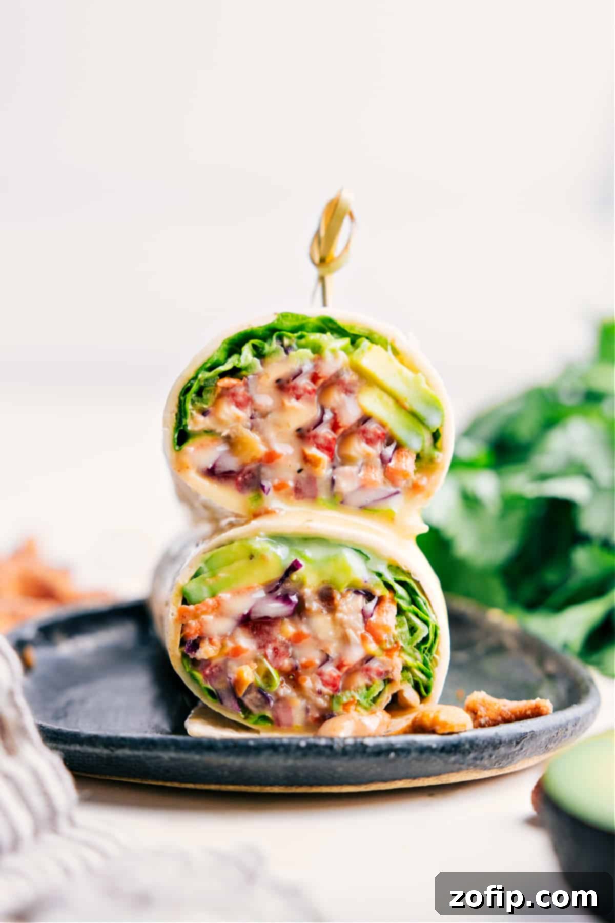 Stacked Cashew Chicken Wraps on a plate, showcasing a healthy and ready-to-eat meal.