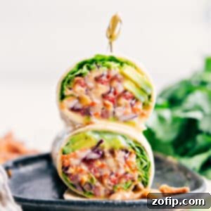 Close-up of a Cashew Chicken Wrap, showing the vibrant filling and creamy sauce.