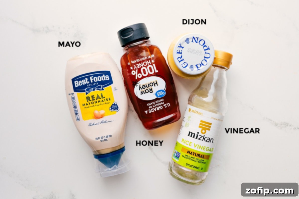 Ingredients for the creamy Cashew Chicken Wrap sauce, including mayonnaise, honey, Dijon mustard, and rice vinegar, neatly prepped for easy mixing.