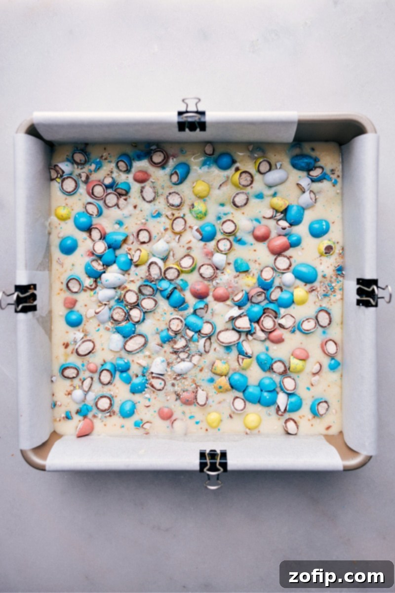 Overhead image of freshly made Robin Egg Fudge in the pan, cut into neat squares and ready to be served, showing the even layer and colorful candy topping.