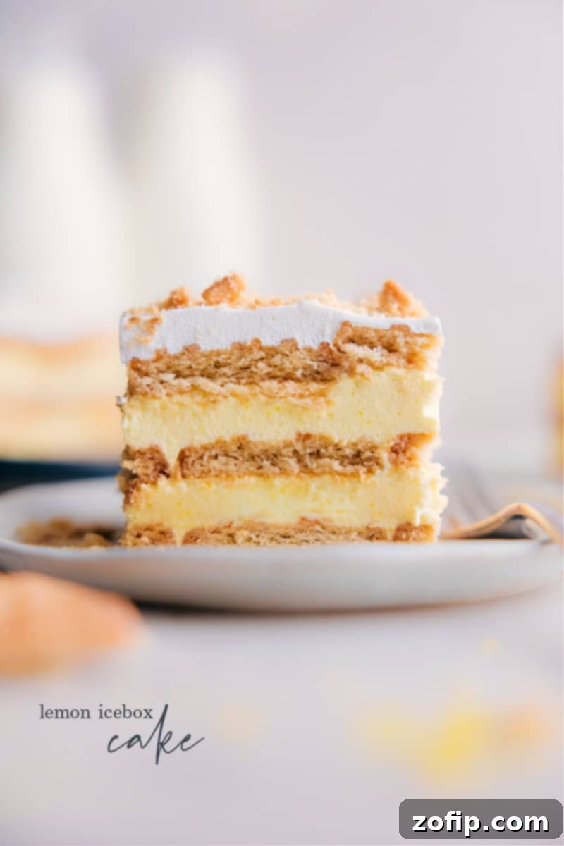 A beautifully sliced piece of Lemon Icebox Cake, showing layers of lemon pudding and shortbread cookies, ready to be enjoyed.