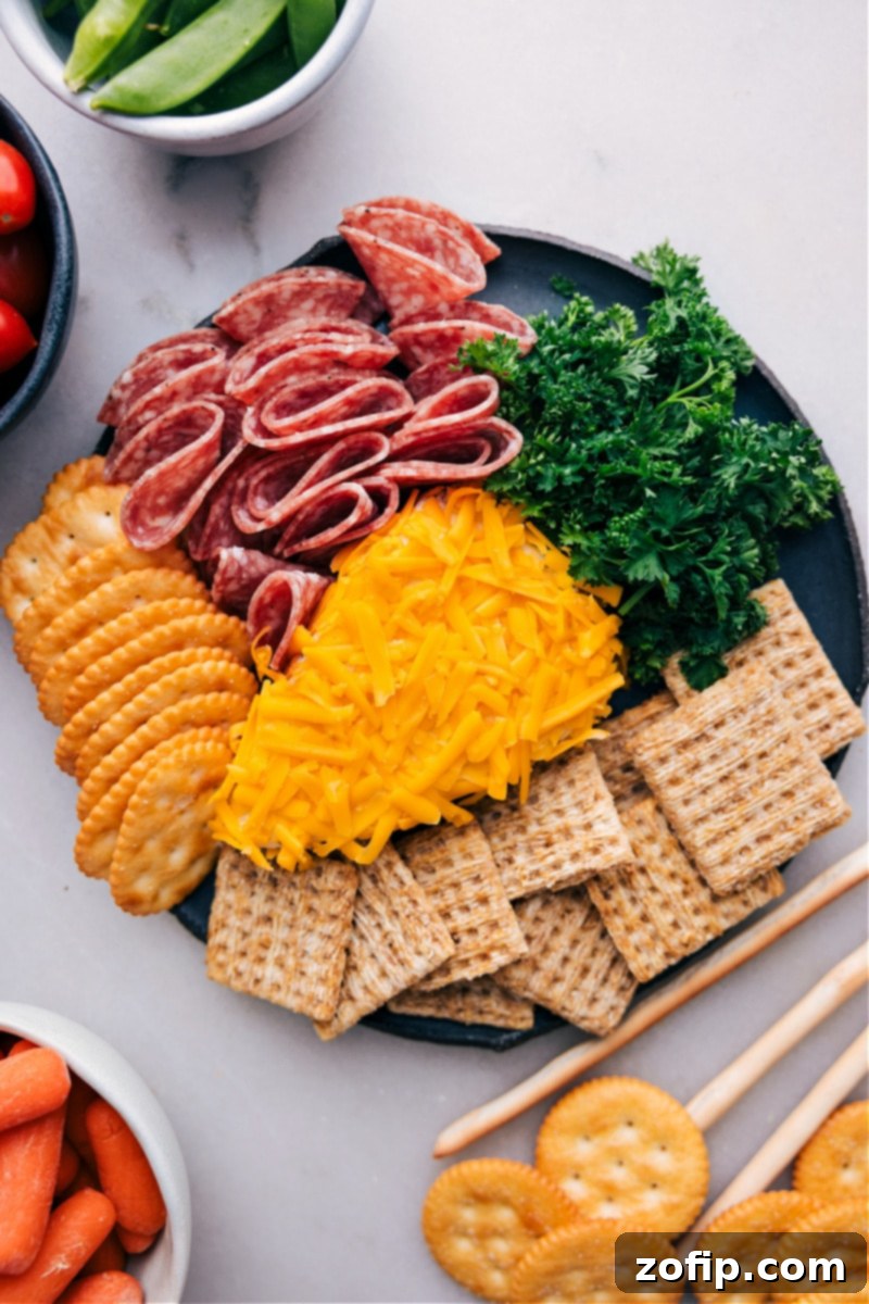 A beautifully arranged serving board featuring the vibrant Carrot Cheeseball as the centerpiece, surrounded by an inviting array of various dippers including crackers, fresh vegetables, and colorful fruits, all ready for a festive party.